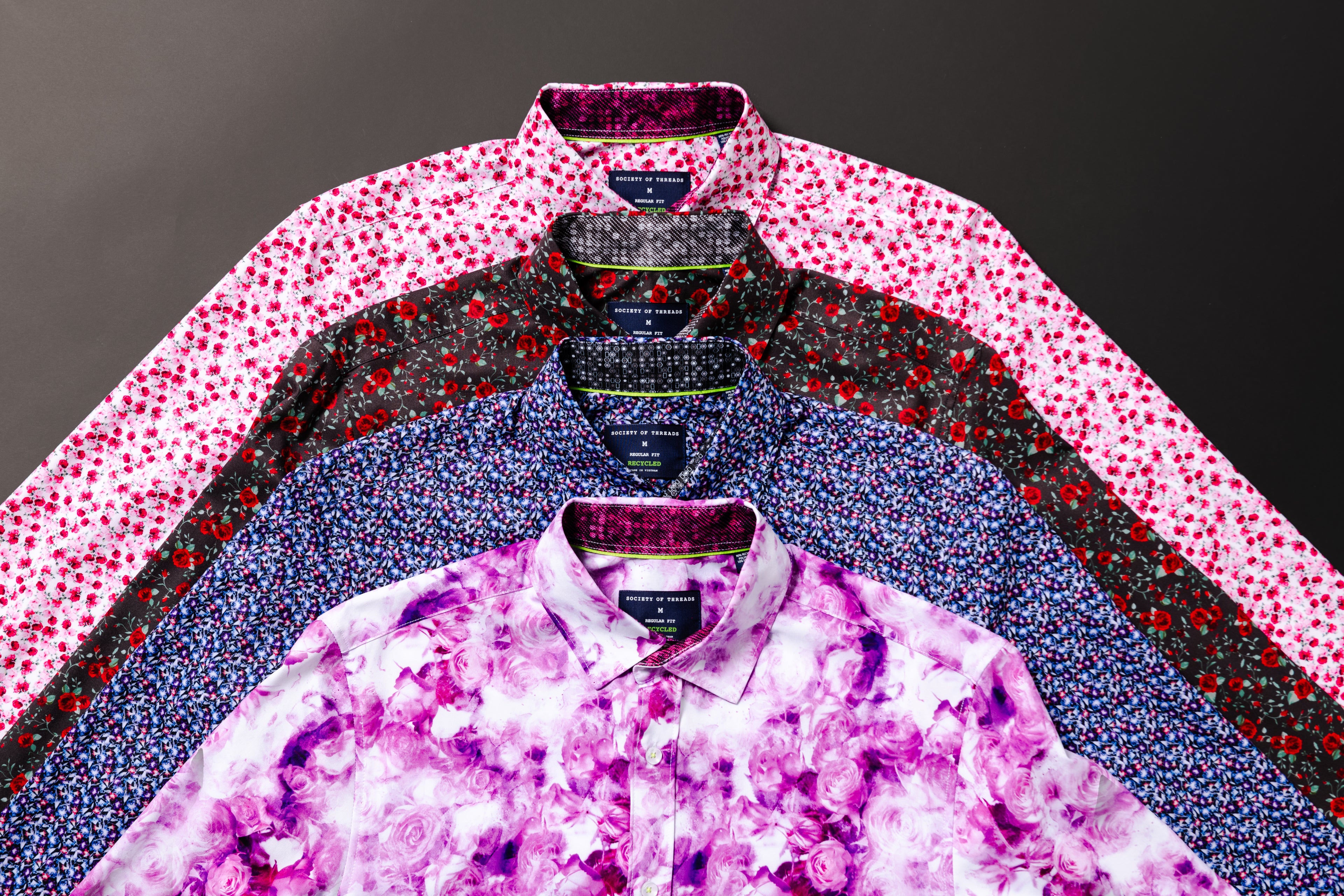 Stack of patterned shirts on a dark background