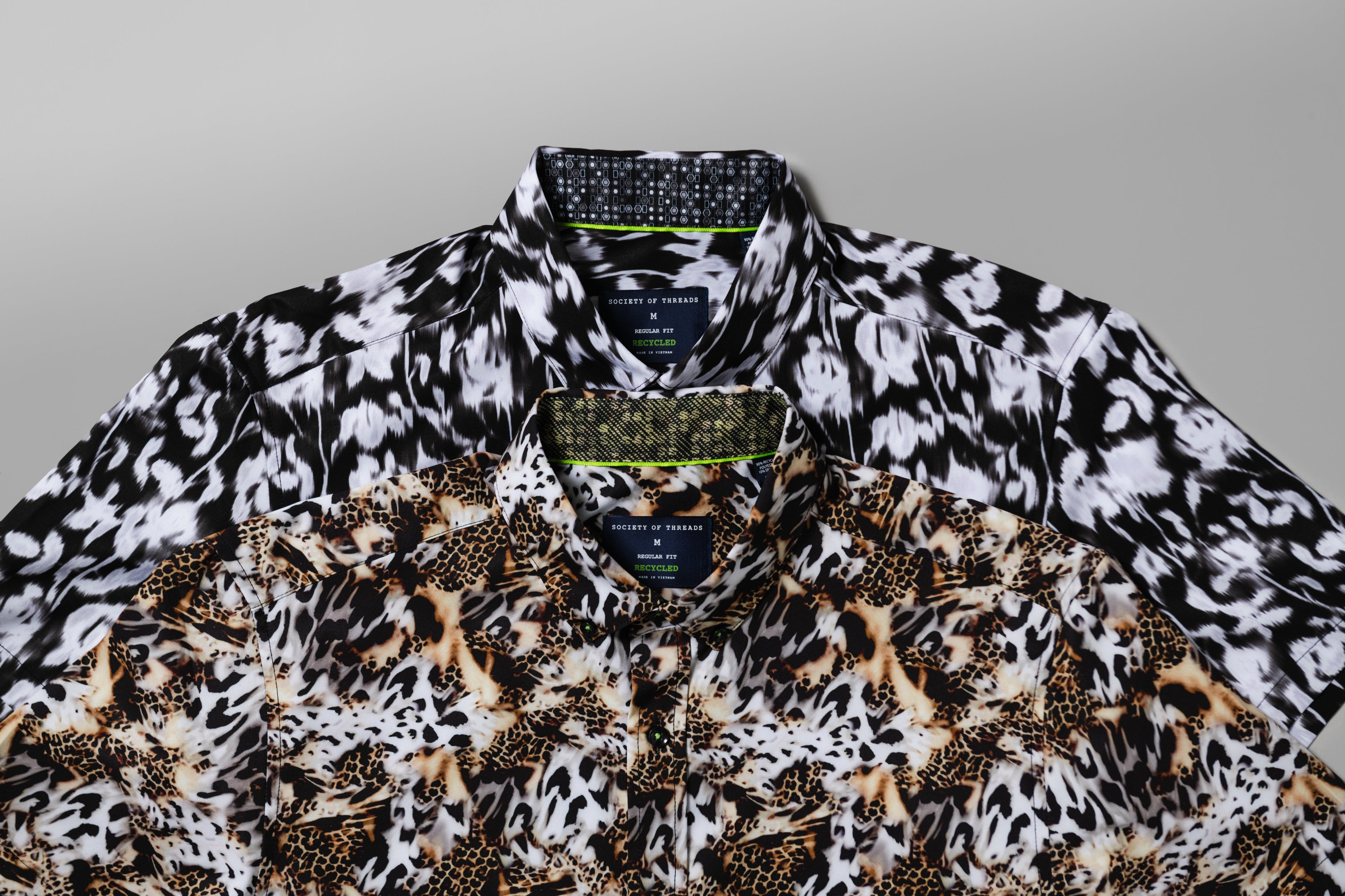 Two stacked pattern shirts with Society of Threads brand label on a gray background