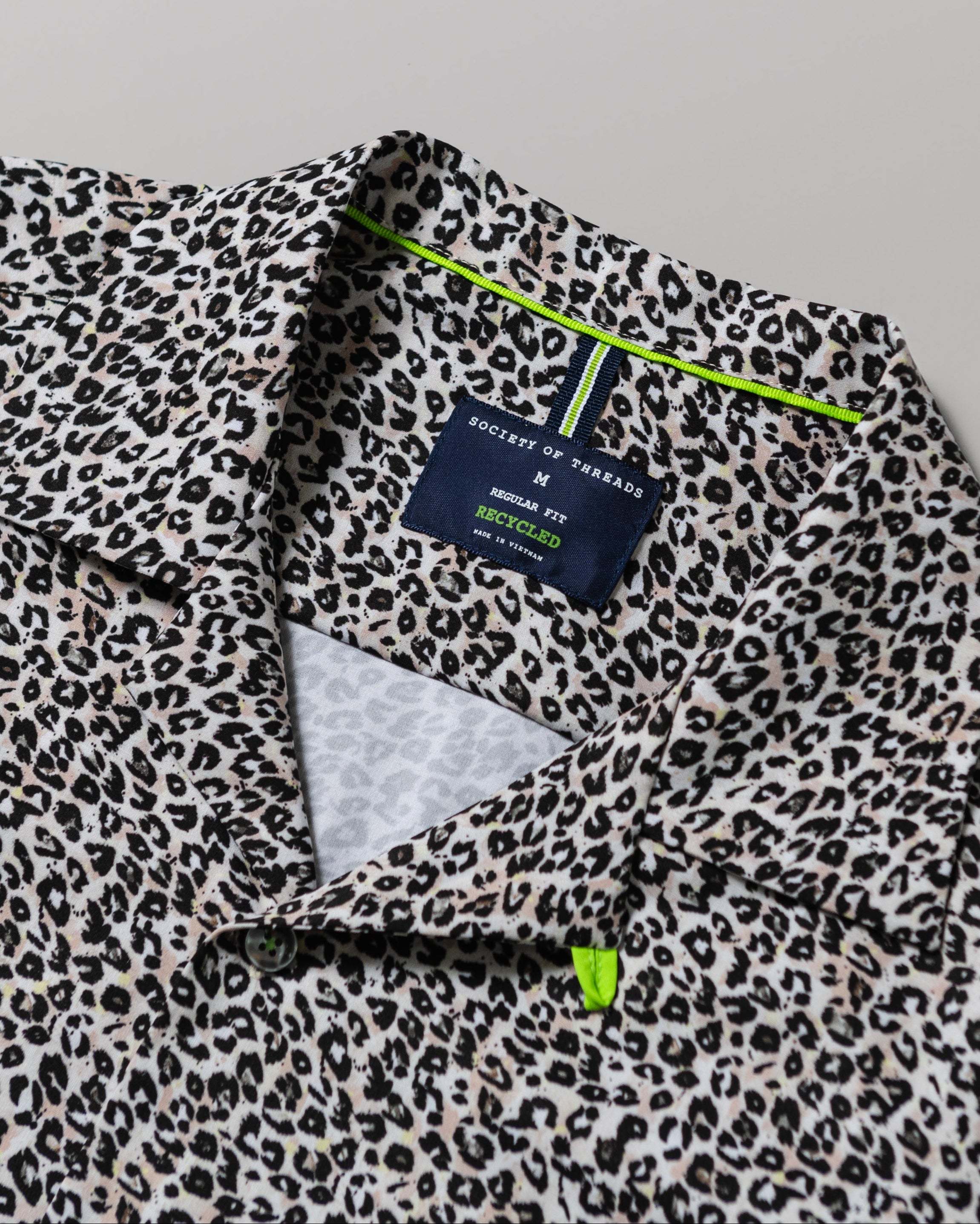 Leopard print shirt with a brand label on a gray background